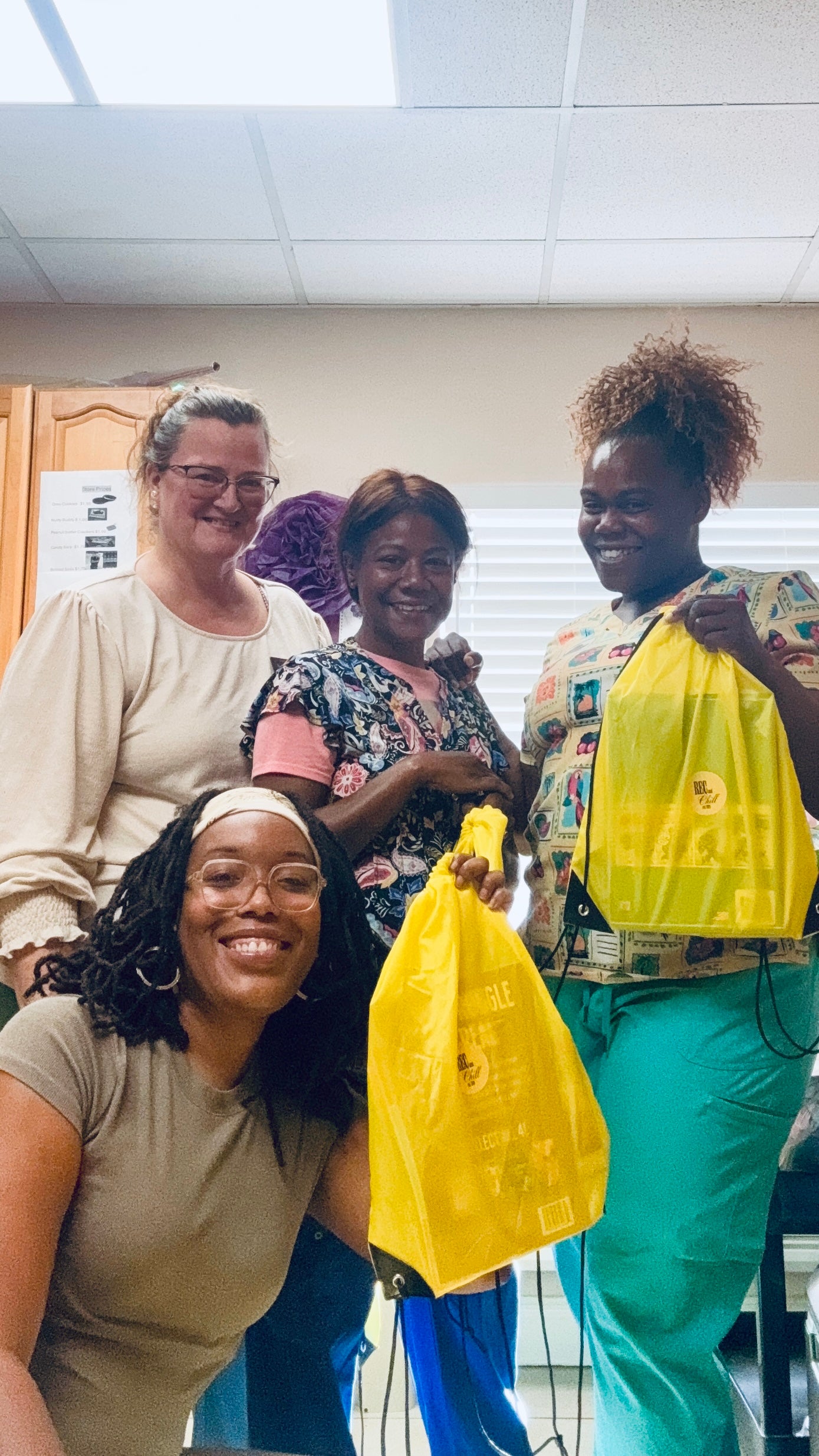 Community members sharing a moment with yellow Rec and Chill Wellness Bags